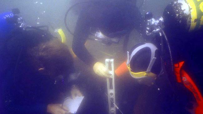 Divers studying a ship at the Newport site where the Endeavour is believed to be among 13 shipwrecks.