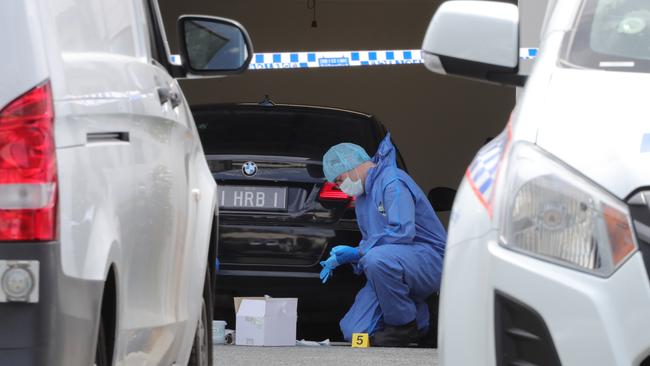 Police examining the driveway where Bowden was fatally shot. Picture: Glenn Hampson