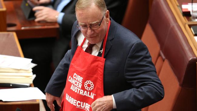 Ian Macdonald in his Cancer Australia Barbecue apron in the Senate yesterday. Picture: Gary Ramage