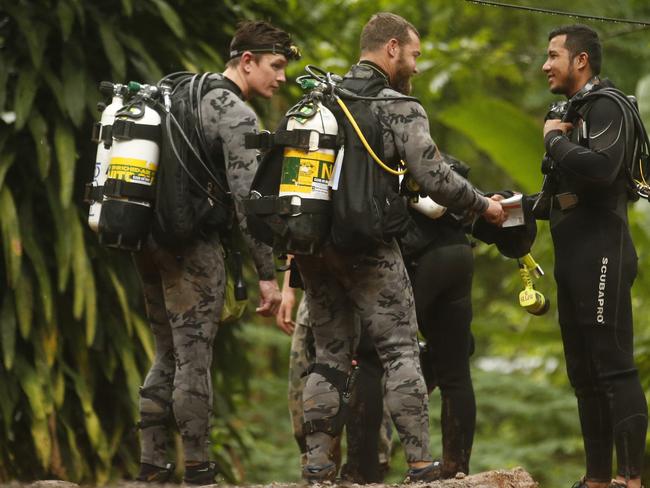 Australian Federal Police divers talk to a Thai rescuer at the scene. Picture: AP