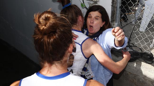 Sonja Hood hugs North Melbourne players in the aftermath of their qualifying final victory over Melbourne. Picture: Michael Klein