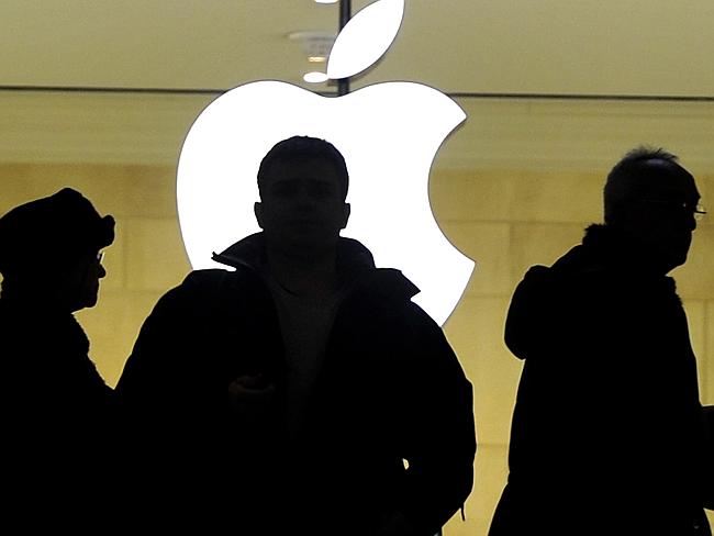 People walk past an Apple store in New York City.