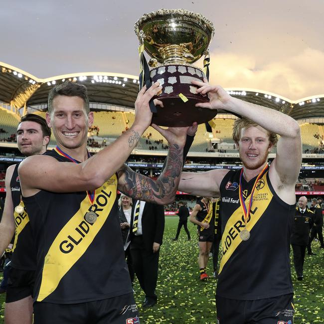 Josh Scott (R) holds up the SANFL premiership cup with former Glenelg ruckman Jesse White. Picture: Sarah Reed