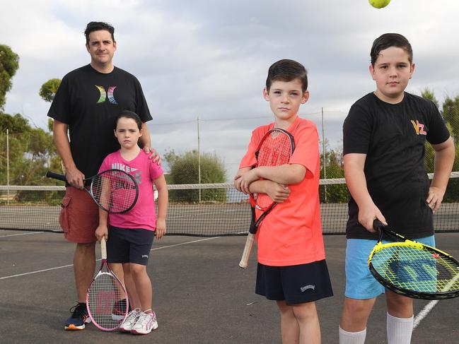 16/2/17 -  Travis Smith and his family are opposing Marion Council plans to carve up McConnell Reserve's tennis courts in Marino, as part of a plan to rip up underused courts throughout the district. Travis is pictured with his twins Maeve and Angus (orange t-shirt), 8 and neighbour Patrick Wesson, 12 (black t-shirt). Photo Naomi Jellicoe