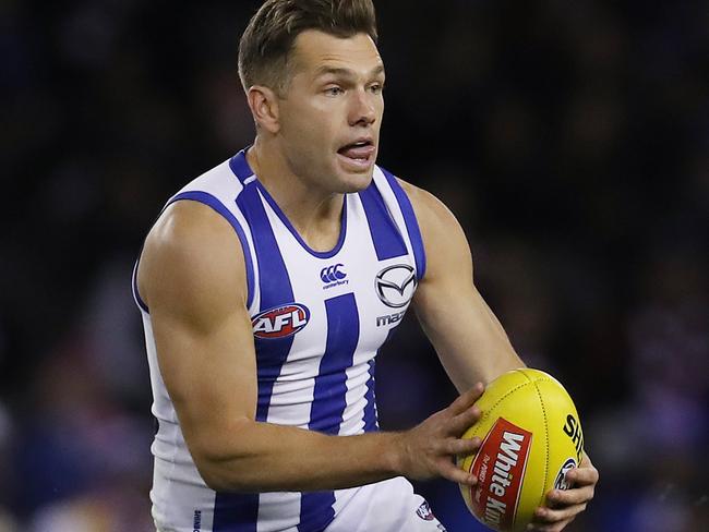 AFL Round 14. Western Bulldogs vs North Melbourne at the Etihad Stadium. North Melbourne's Shaun Higgins looks for an option as Western Bulldogs Marcus Bontempelli chases   . Pic: Michael Klein