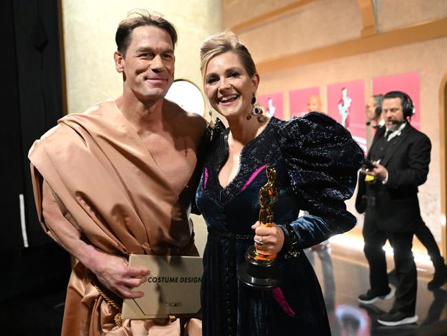 John Cena and Holly Waddington are seen backstage during the 96th Annual Academy Awards at Dolby Theatre after he presented her with an Oscar. Picture: Richard Harbaugh/A.M.P.A.S. via Getty Images