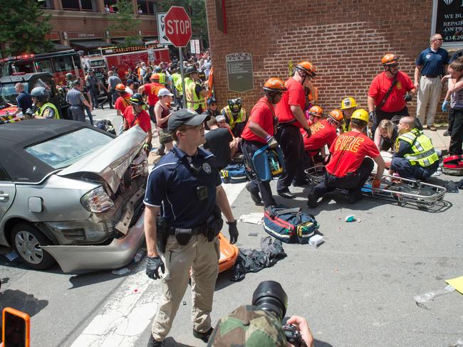 A woman receives first-aid after a car accident ran into a crowd of protesters in Charlottesville, Virginia, as the city braced for a flood of white nationalist demonstrators as well as counter-protesters, declaring a local emergency as law enforcement attempted to quell early violent clashes. Picture: AFP