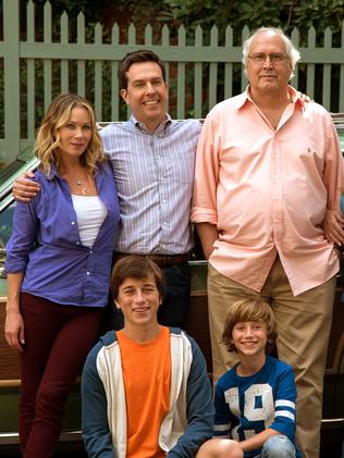 In this image released by Warner Bros. Entertainment, Christina Applegate, standing from left, Ed Helms, Chevy Chase, Beverly D'Angelo, and Skyler Gisondo, kneeling left, and Steele Stebbins appear in a scene from 