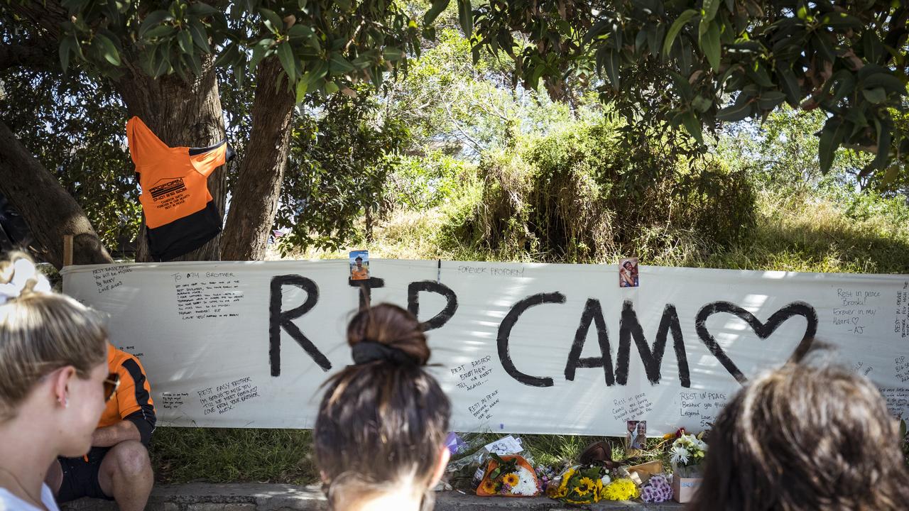 Friends and work colleagues mourn the death of Cameron Smith at a roadside tribute near the Seaford train station. Picture: NCA NewsWire / Chris Hopkins