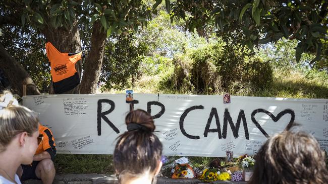 Friends and work colleagues mourn the death of Cameron Smith at a roadside tribute near the Seaford train station. Picture: NCA NewsWire / Chris Hopkins