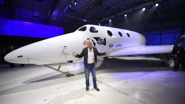 Sir Richard Branson poses in front of Virgin Galactic's SpaceShipTwo space tourism rocket. Picture: AP