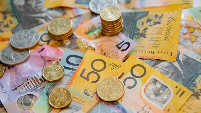 Australian notes and coins spilled out on a table