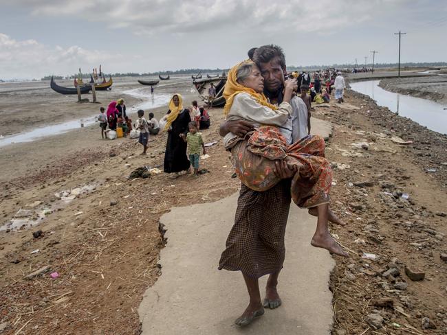 A Rohingya man carries his mother to a refugee camp in Bangladesh. Picture: Dar Yasin
