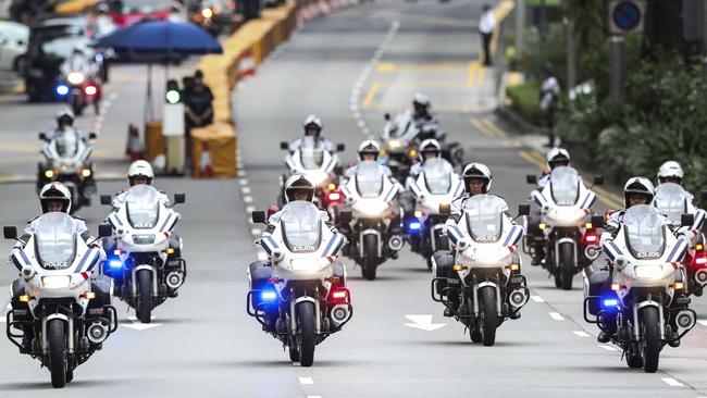 Singaporean police escort Kim’s motorcade as it leaves the St. Regis Hotel for the summit. Picture: AP