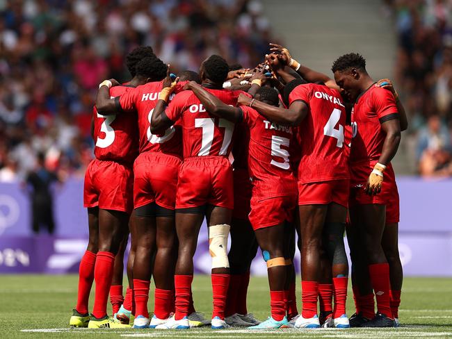 PARIS, FRANCE - JULY 24: Players of Team Kenya huddle prior to the Men's Rugby Sevens Pool B Group match between Argentina and Kenya on Day -2 of the Olympic Games Paris 2024 at Stade de France on July 24, 2024 in Paris, France. (Photo by Cameron Spencer/Getty Images)