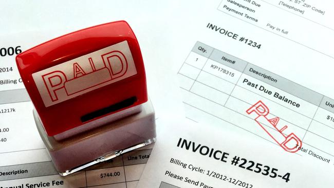 stack of invoices have been paid and marked paid by a red rubber stamp. some of the invoices contained a passed due balance. generic bill paid.