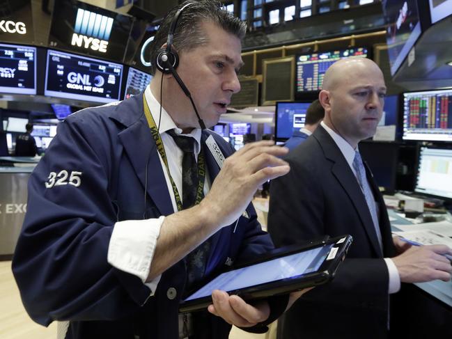 FILE - In a March 30, 2016 file photo, trader William McInerney, left, and specialist Jay Woods work on the floor of the New York Stock Exchange. Stock indexes were trading in a narrow range in early trading Monday, April 4, 2016, as investors worked through several company announcements. Global markets were modestly higher. (AP Photo/Richard Drew, File)
