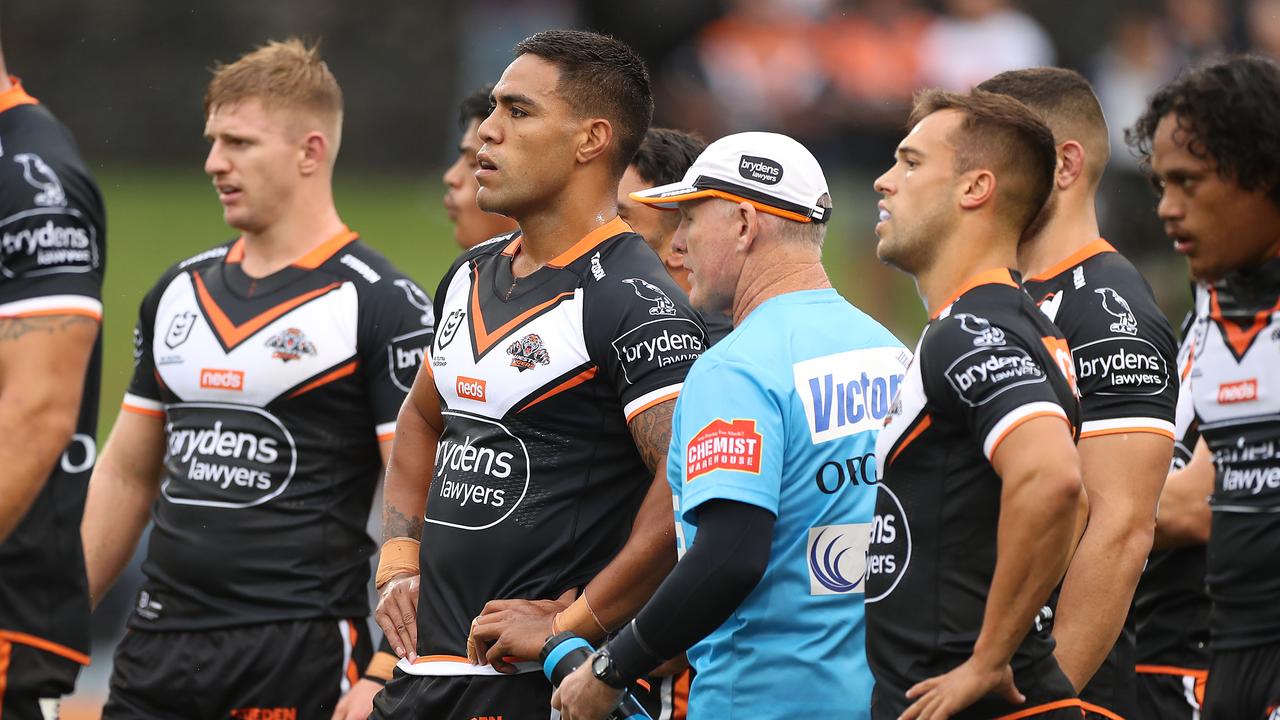Tigers players look on after conceding a try against the Roosters.