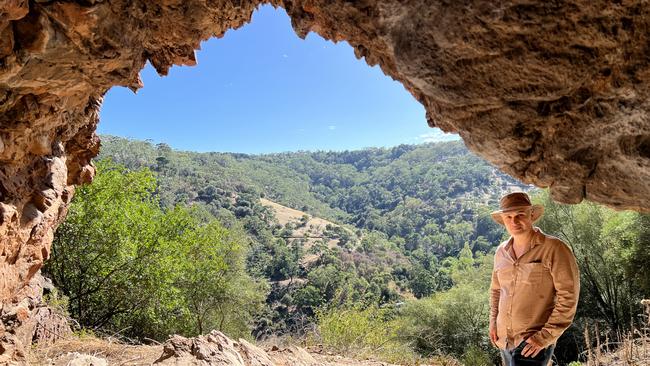 A rock shelter with unknown cultural heritage value, known to climbers as the Bachelor Pad, near Horsnell Gully Conservation Park could be destroyed in the expansion of Hanson's White Rock Quarry. Residents group leader, Demetrios (Jim) Bastiras of Skye at the site. Picture: Clare Peddie