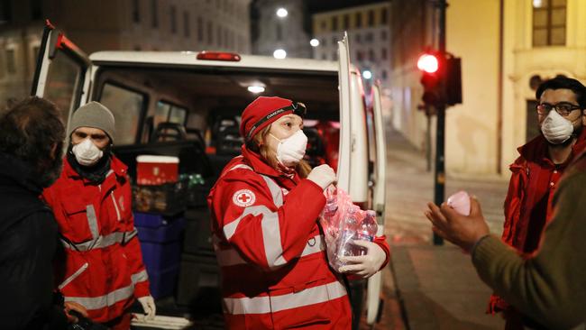 Members of the Italian Red Cross assist homeless people sleeping on the street in the historic city centre in Rome, Italy. Picture: Getty Images