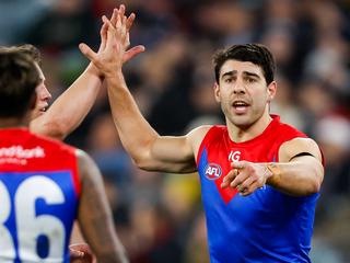 MELBOURNE, AUSTRALIA - AUGUST 12: Christian Petracca of the Demons celebrates a goal with teammates during the 2023 AFL Round 22 match between the Carlton Blues and the Melbourne Demons at Melbourne Cricket Ground on August 12, 2023 in Melbourne, Australia. (Photo by Dylan Burns/AFL Photos via Getty Images)