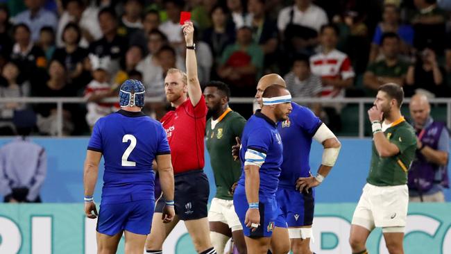 Referee Wayne Barnes shows a red card to Italy's Andrea Lovotti (right) during the Rugby World Cup Pool B game at Shizuoka Stadium.