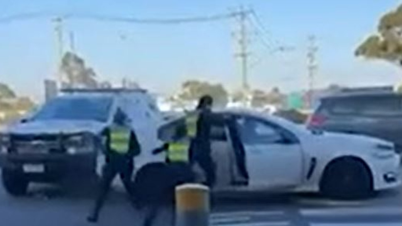 Driver caught on video ramming police cars at shopping centre