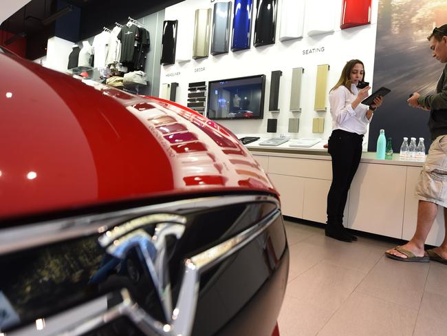 A sales representative (L) helping a customer pre-order, the as yet unseen Tesla Model 3, in the Tesla store in Santa Monica, California. Picture: AFP