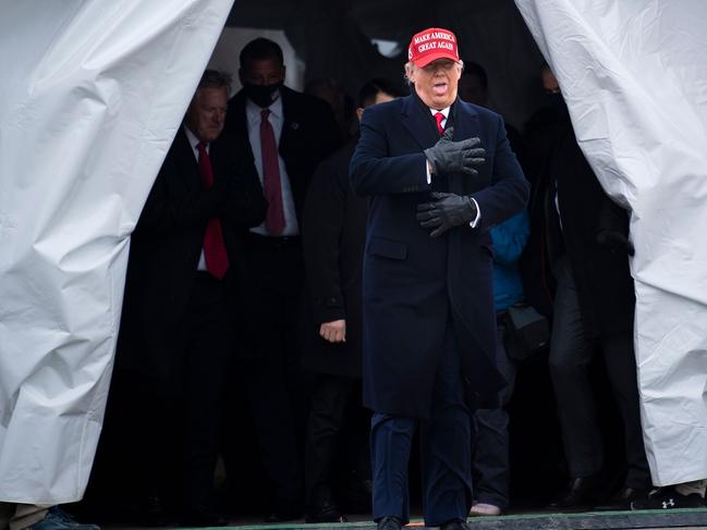 Donald Trump reacts to the cold in Washington, Michigan. Picture: AFP.