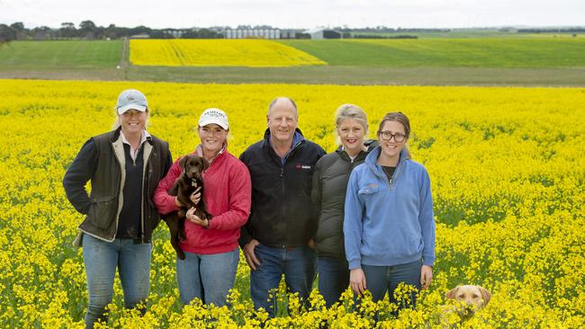 Luke and Christina Fay, with their daughters (from left) Isobel, George, and Kate on their Carranballac farm with their canola crop. Picture: Zoe Phillips