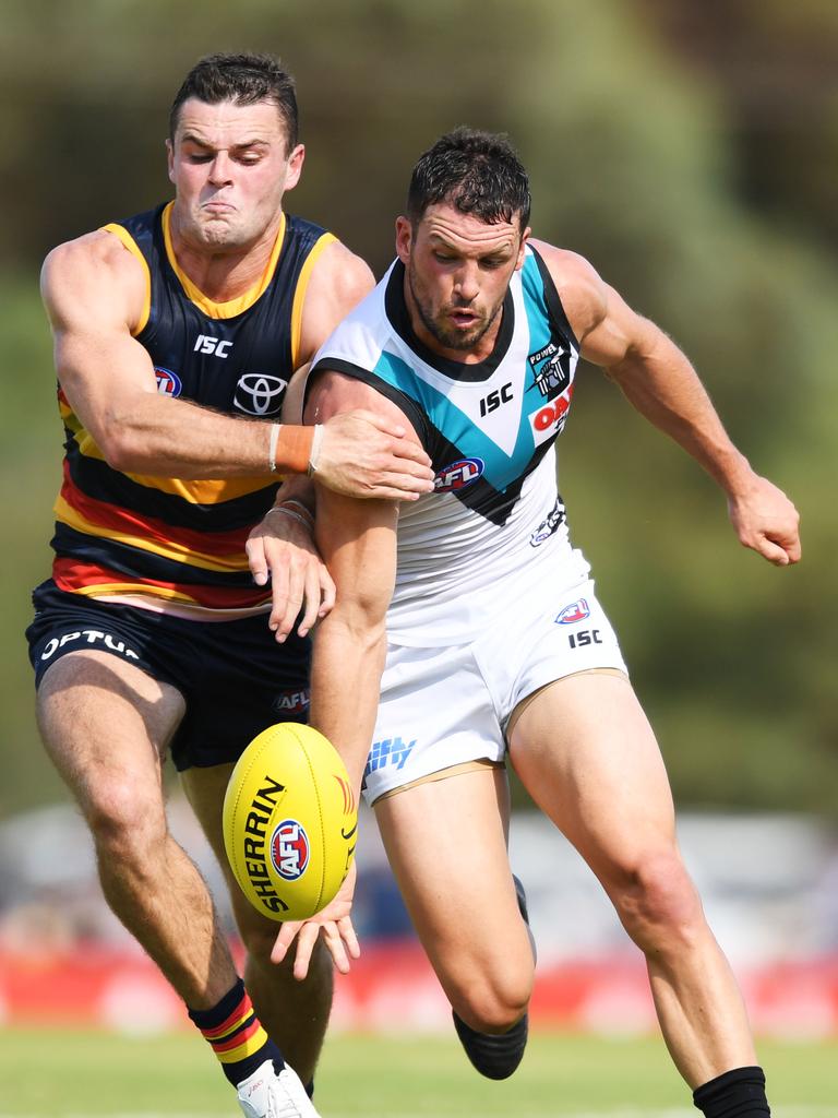  Brad Crouch goes head to head with Port Adelaide’s Travis Boak during the JLT Series in Port Pirie. Picture: Mark Brake/Getty Images