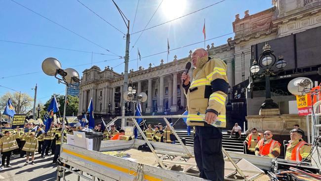 Senior government minister Ben Carroll was booed by angry protestors as he walked past the rally. Picture: Valeriu Campan