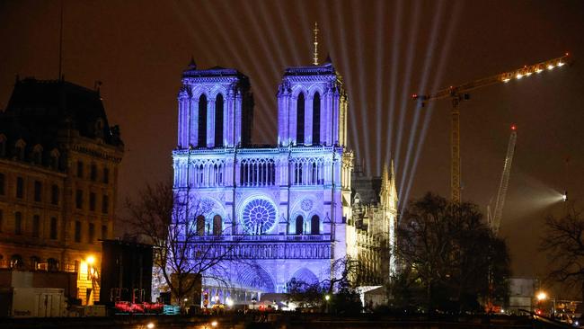 Notre Dame illuminated along the Seine two days before it reopening this weekend. Picture: AFP