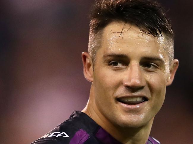 WOLLONGONG, AUSTRALIA - APRIL 30: Cooper Cronk of the Storm smiles as he watches on during the round nine NRL match between the St George Illawarra Dragons and the Melbourne Storm at WIN Stadium on April 30, 2017 in Wollongong, Australia. (Photo by Mark Kolbe/Getty Images)