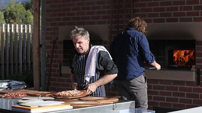 Chefs Adrian Mathews, left, and Andrew Clark at a wood-fired oven public baking day on the Queen’s Domain, Hobart. Picture: LUKE BOWDEN