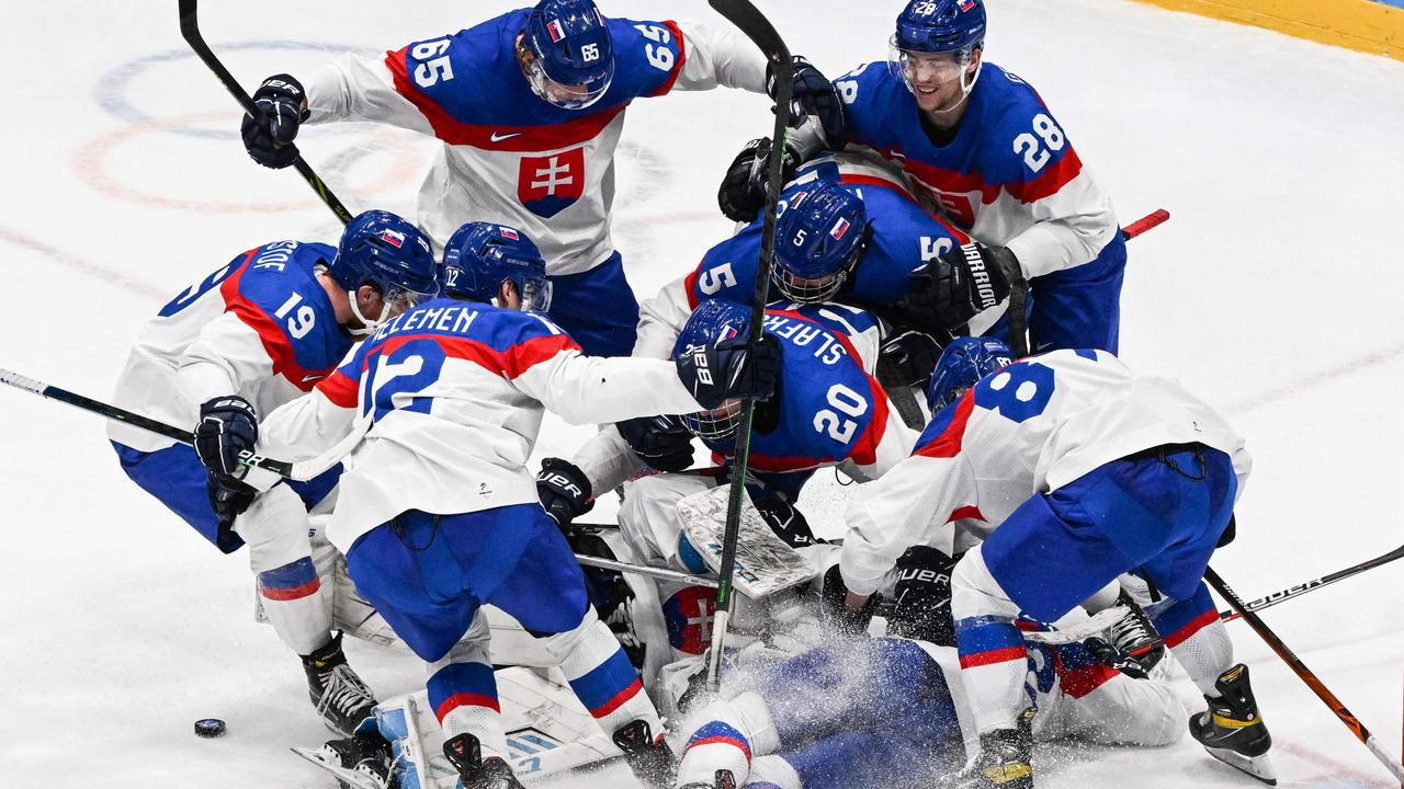 Slovakia's players celebrate victory. Photo by ANTHONY WALLACE / AFP.