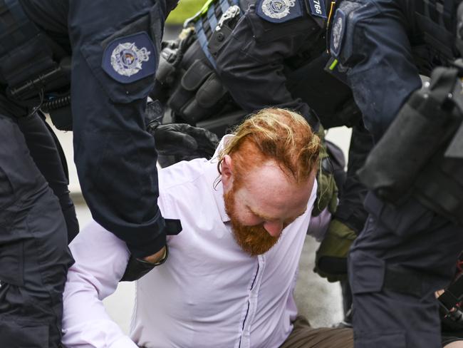 CANBERRA, AUSTRALIA - NewsWire Photos - November 27, 2024: Rising tide protesters against coal block the road in-front of Parliament House in Canberra. Picture: NewsWire / Martin Ollman