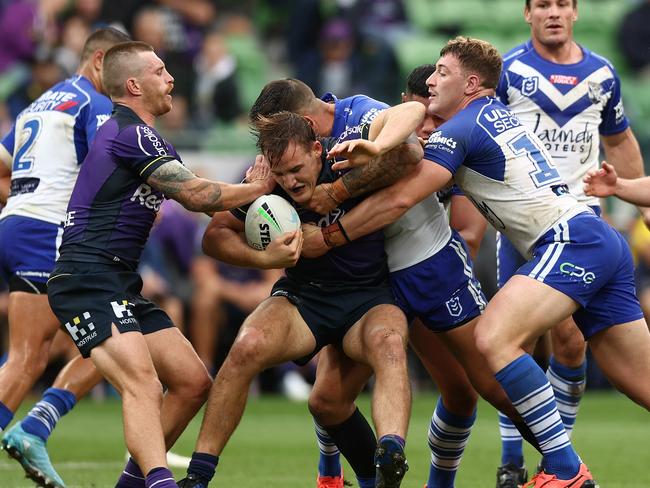 MELBOURNE, AUSTRALIA - APRIL 03: Alec MacDonald of the Storm is tackled during the round four NRL match between the Melbourne Storm and the Canterbury Bulldogs at AAMI Park on April 03, 2022, in Melbourne, Australia. (Photo by Graham Denholm/Getty Images)