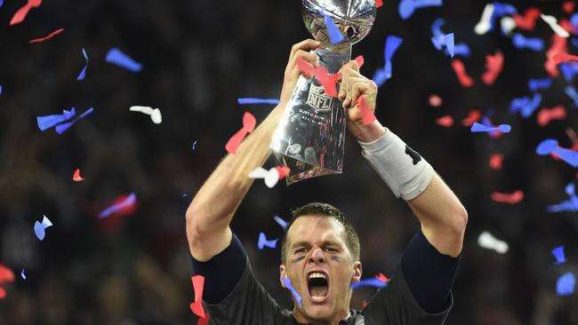 TOPSHOT - Tom Brady #12 of the New England Patriots holds the Vince Lombardi Trophy after defeating the Atlanta Falcons 34-28 in overtime during Super Bowl 51 at NRG Stadium on February 5, 2017 in Houston, Texas. The Patriots defeated the Falcons 34-28 after overtime.  / AFP PHOTO / Timothy A. CLARY