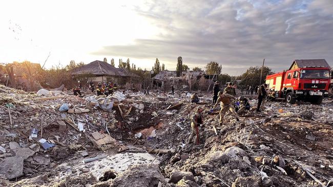 A handout picture taken and released by National Police of Ukraine yesterday shows rescuers working among debris following the shelling of a residential building in Zaporizhzhia, Ukraine. Picture: Supplied