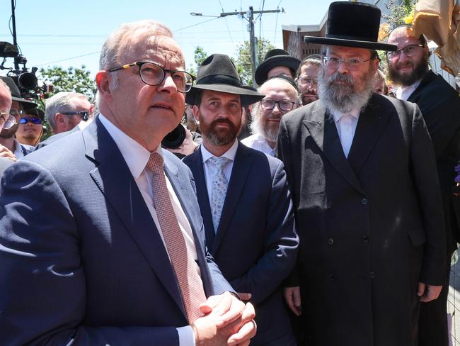 Prime Minister Anthony Albanese visits the fire damaged Adass Israel Synagogue in Ripponlea. The PM is greated by Jewish community leaders and walks to the temporary fence covered in flowers.                                                             Picture: David Caird