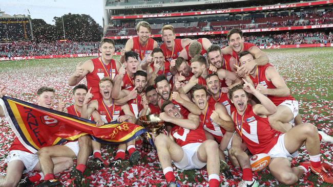 North Adelaide players celebrate with the Thomas Seymour Hill premiership trophy at Adelaide Oval.  Picture SARAH REED