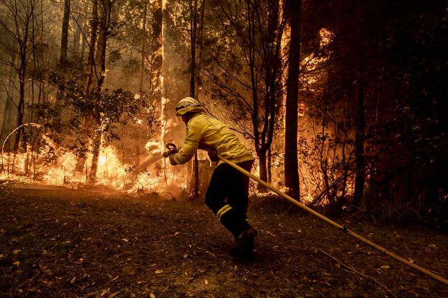 RFS firefighters desperately worked to save a home on Willinga Drive at Bawley Point, on the NSW south coast. Picture: Gary Ramage