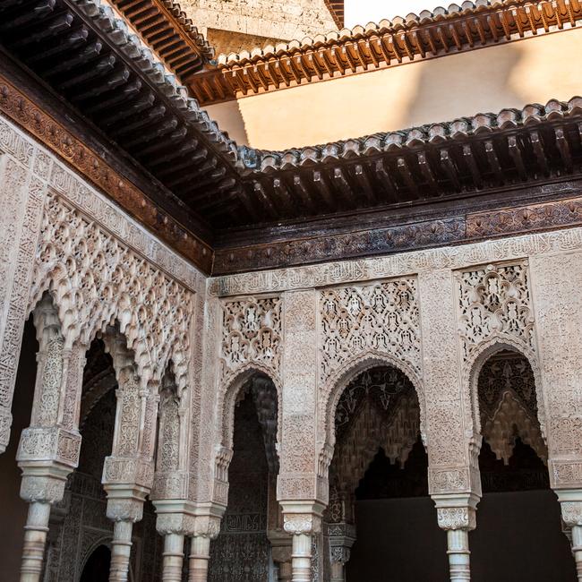 Inner courtyard in the Alhambra of Granada with columns and arches of Arabic style.