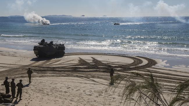 Amphibious assault vehicles with the United States military, Australian Defence Force and Japan Self-Defense Force simulate a combined force entry assault operation for a drill in Shoalwater Bay Training Area, Australia.