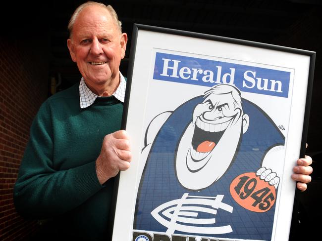 Ken Hands holds a Herald Sun poster from the infamous 1945 ‘Bloodbath’ Grand Final.