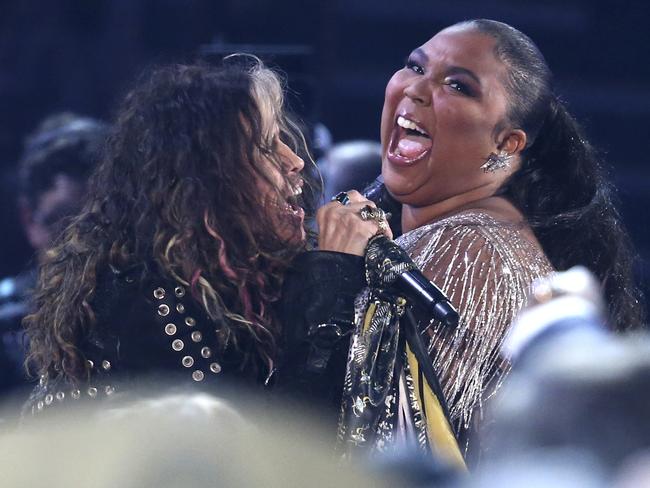 Steven Tyler, left, of the musical group Aerosmith, and Lizzo are seen in the audience as he performs at the 62nd annual Grammy Awards. Picture: AP