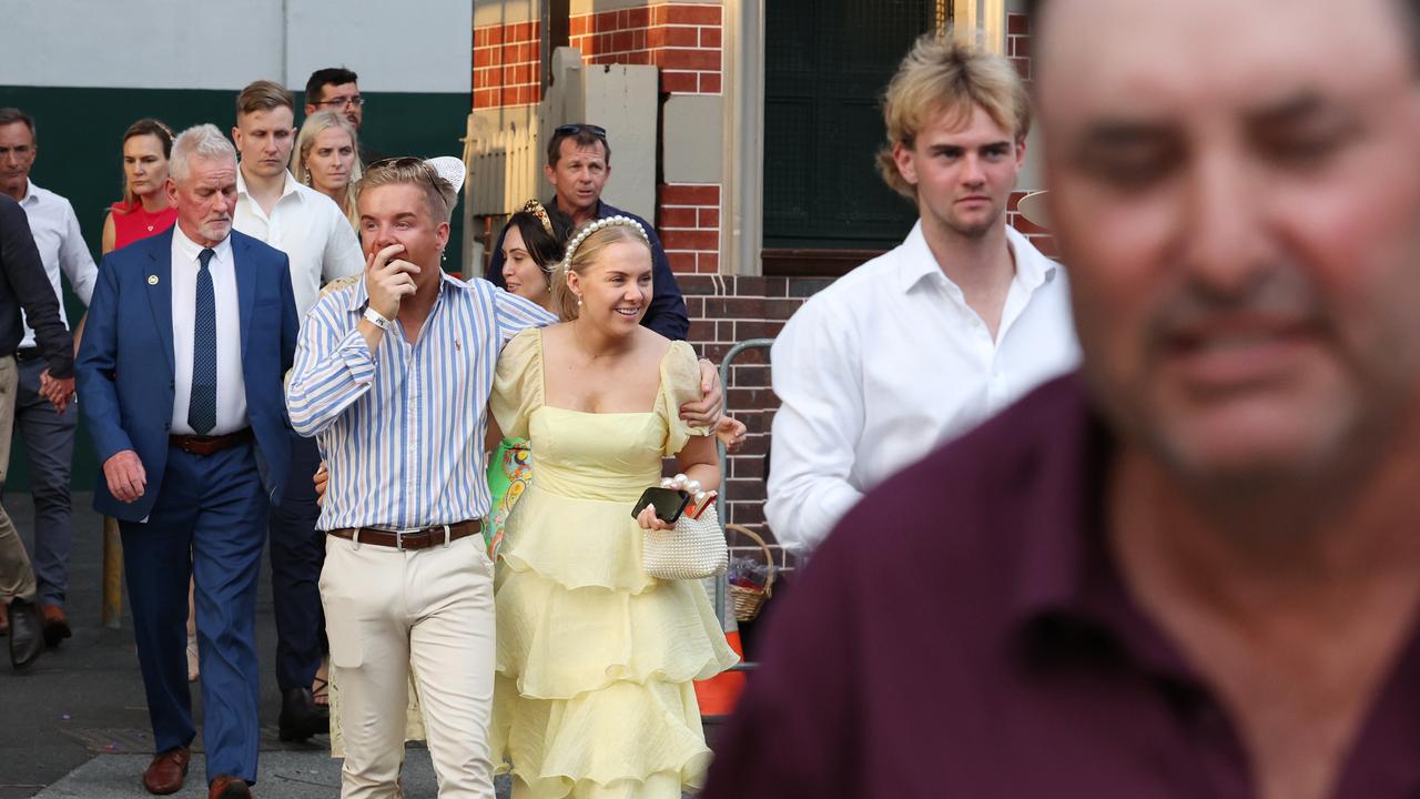 Punters leave Eagle Farm racecourse on Melbourne Cup Day.