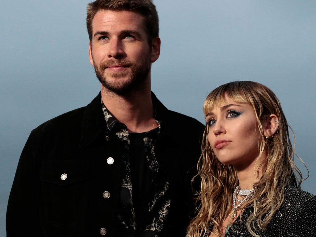 Liam Hemsworth and Miley Cyrus. Picture: Kyle GRILLOT / AFP.