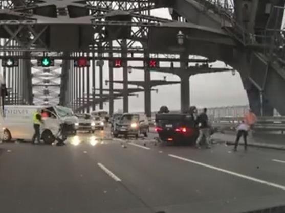 Carnage … bystanders rush to help the drivers after the crash.